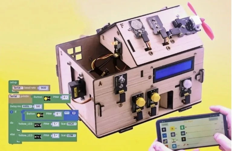 Ilustrace elektronického zařízení s ovládacím panelem, programovacími bloky a tabletem