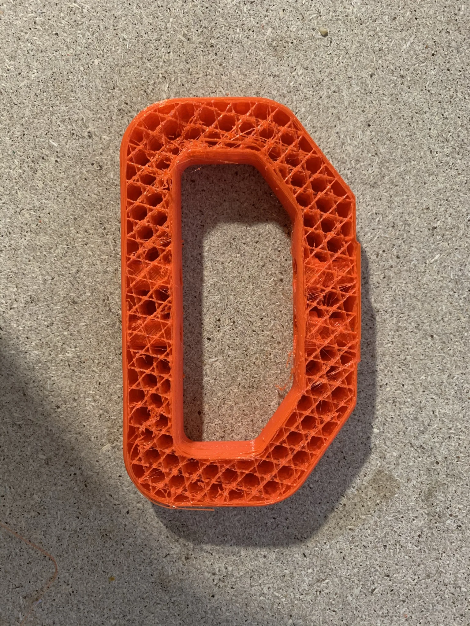 Oranžový 3D výtisk s voštinovou výplní na tiskové podložce