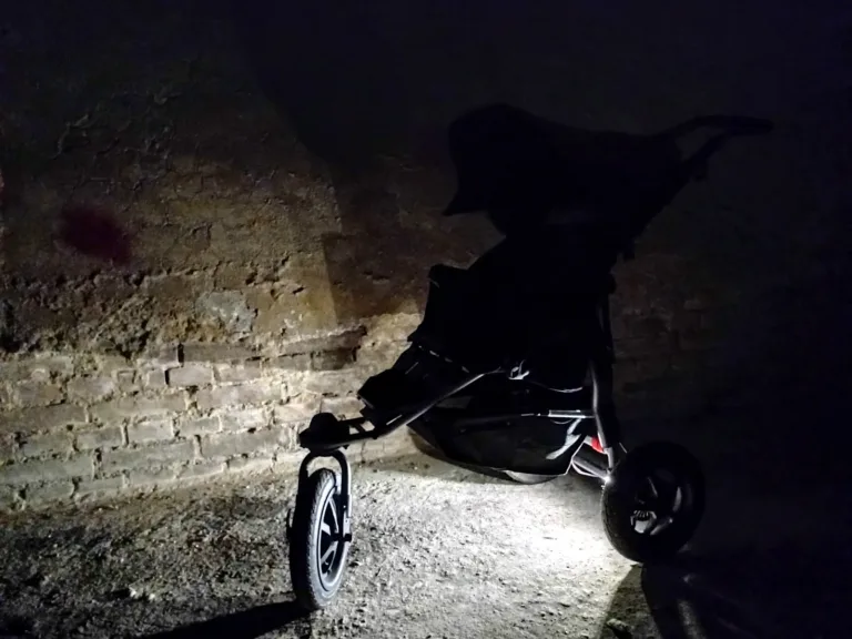 Kočárek osvětlený barevnými RGB LED pásky v noční ulici