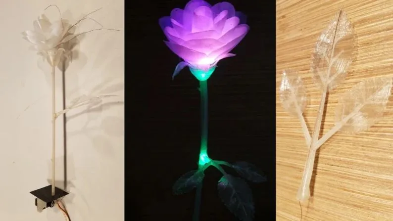 Tři varianty 3D tisknuté růže, uprostřed svítící fialová květina
